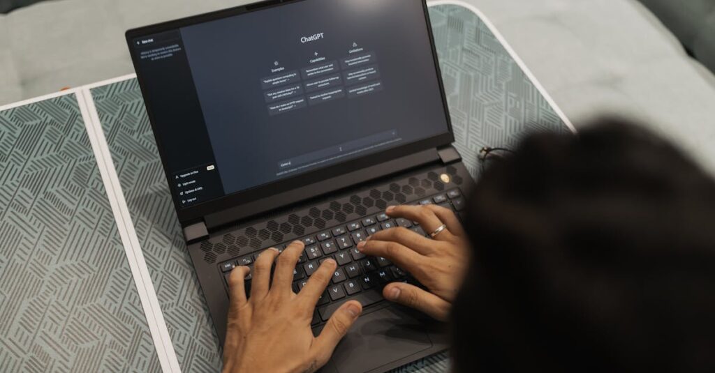 pexels-photo-16094042-16094042 Close-up of hands typing on a laptop displaying ChatGPT interface indoors.