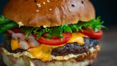 Juicy cheeseburger with bacon, lettuce, tomato, and sesame seed bun.