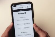 Close-up of hands holding a smartphone displaying the ChatGPT application interface on the screen.
