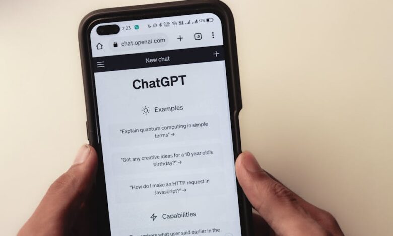 Close-up of hands holding a smartphone displaying the ChatGPT application interface on the screen.