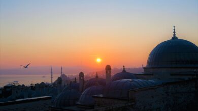Beautiful view of Istanbul's mosques at sunset with vibrant sky and silhouettes.