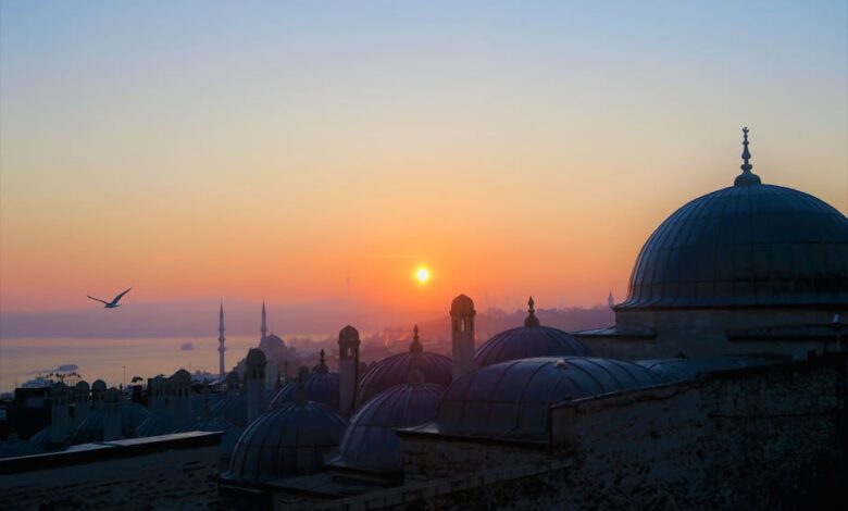 Beautiful view of Istanbul's mosques at sunset with vibrant sky and silhouettes.