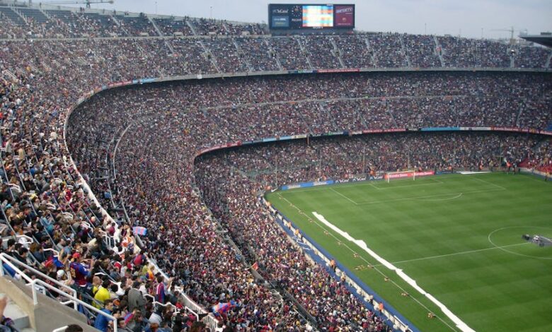 A packed stadium with enthusiastic fans watching an exciting soccer match.