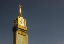 Majestic capture of the Abraj Al Bait Clock Tower in Mekkah against a clear sky.
