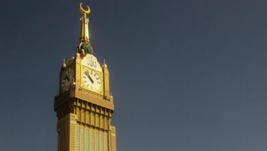Majestic capture of the Abraj Al Bait Clock Tower in Mekkah against a clear sky.