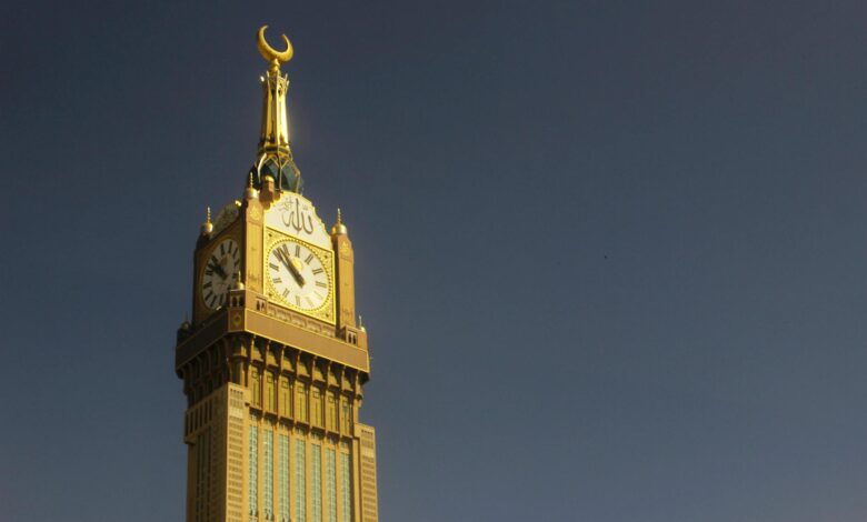 Majestic capture of the Abraj Al Bait Clock Tower in Mekkah against a clear sky.