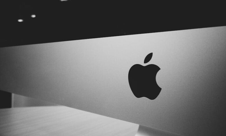 Close-up of a black and white Apple logo on a desktop screen with a modern minimalist design.